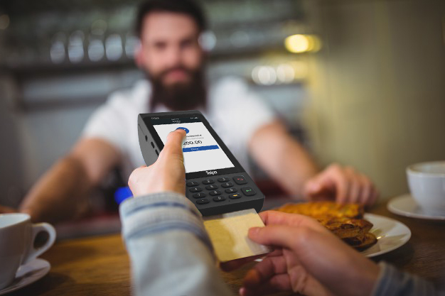 customer-making-payment-through-payment-terminal-counter_1170-648.jpg